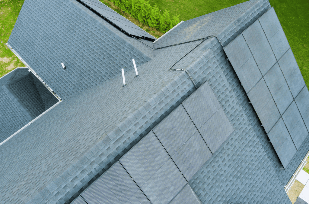Complex shingle roof with multiple ridges and solar panels, showing how roof shape can influence balanced attic ventilation.