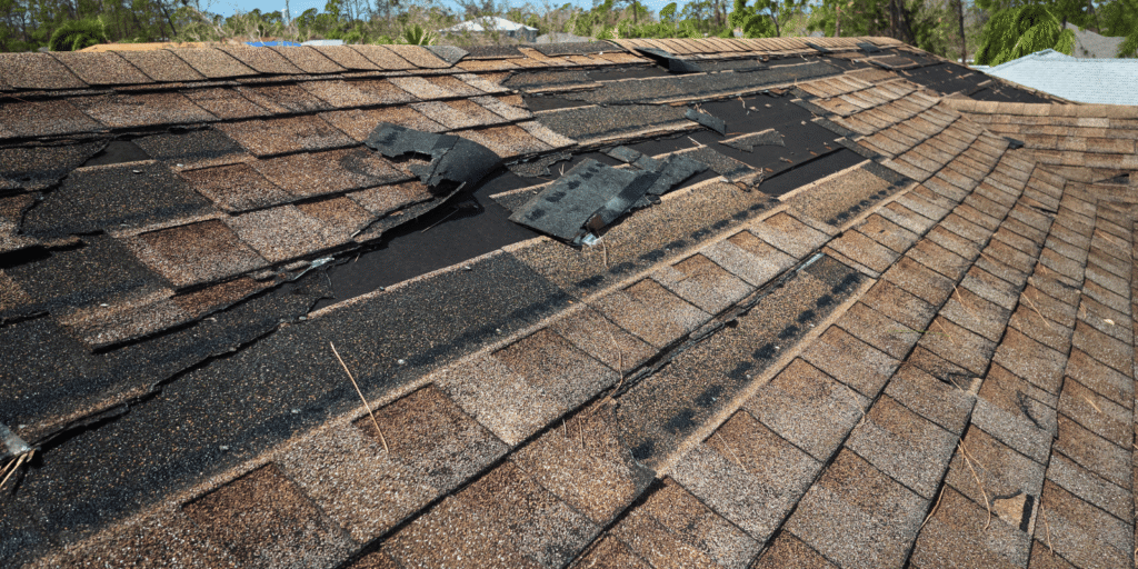 Damaged flat roof membrane near rooftop equipment showing surface wear, cracks, and hidden leak risk on a commercial roof