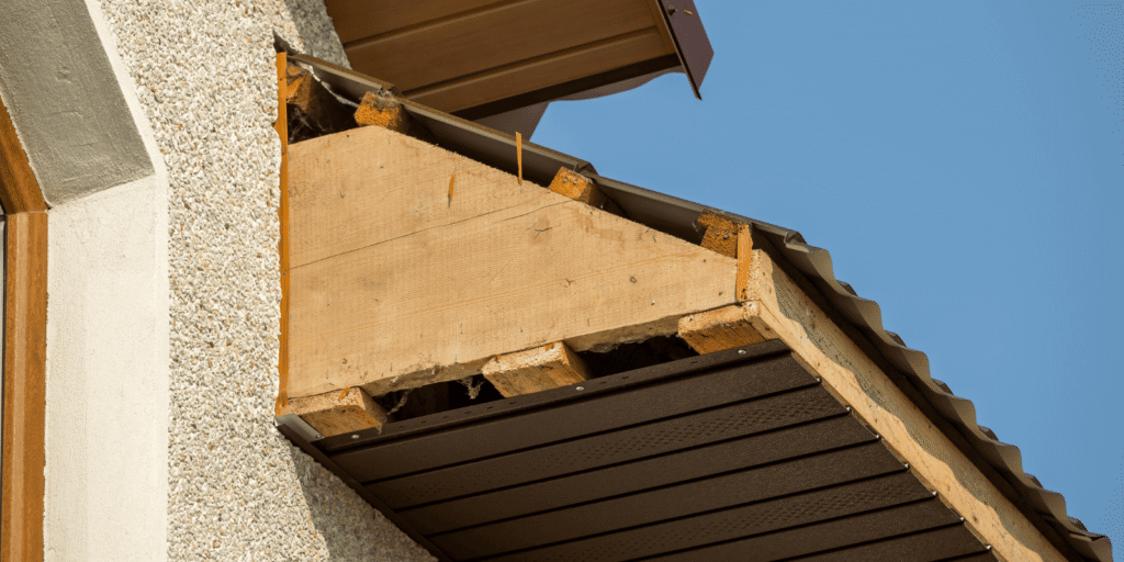 Exposed fascia board and soffit area under a roof edge during rotted fascia board repair on a Boston home exterior project