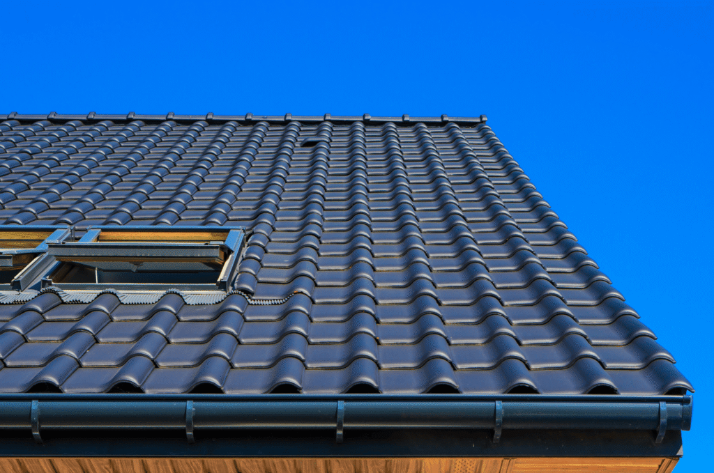 Clean gutter along a tiled roof edge shedding water correctly, the fix for common gutter and downspout issues on a home