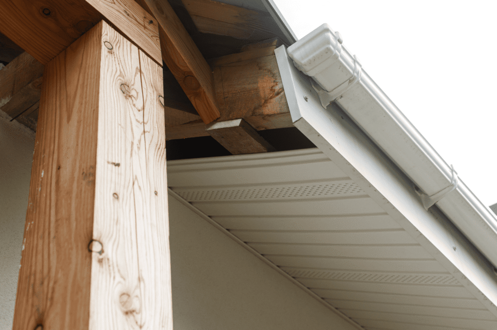 Gap under a home's soffit exposing bare rafters, a clear sign of damaged soffit and early soffit and fascia damage to watch
