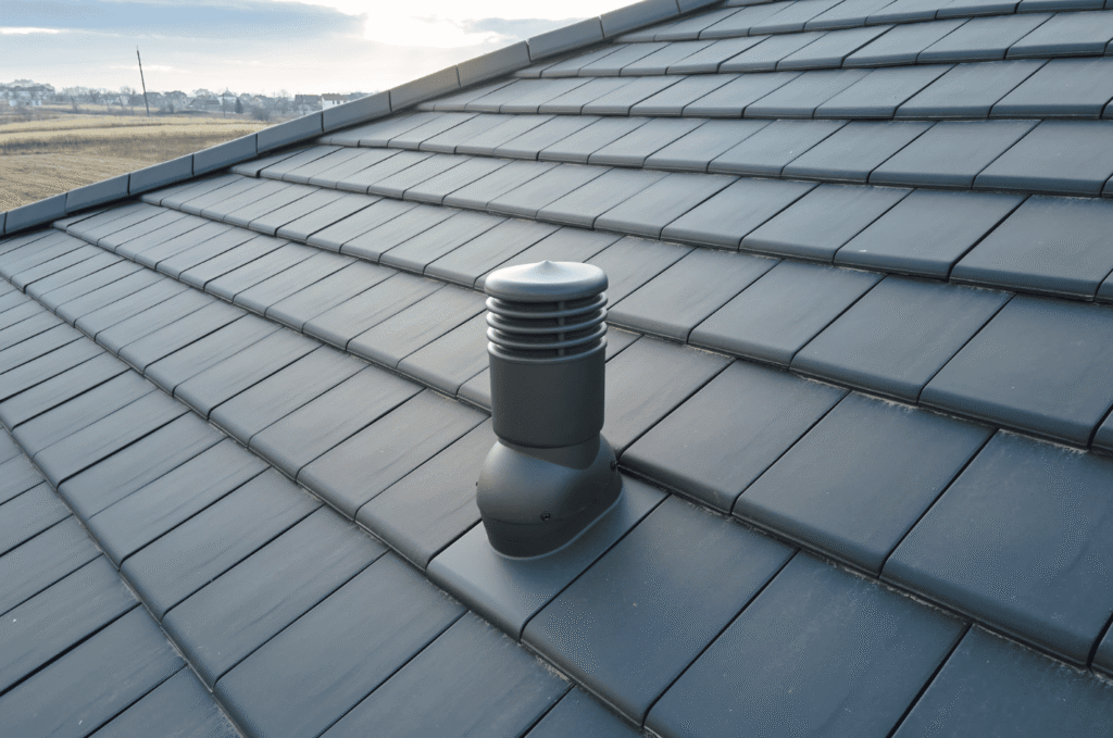 Roof vent installed on a tiled roof that lets warm attic air escape, a key part of preventing poor roof ventilation problems