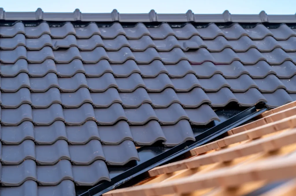 A contractor completing roof repair on a sloped residential roof