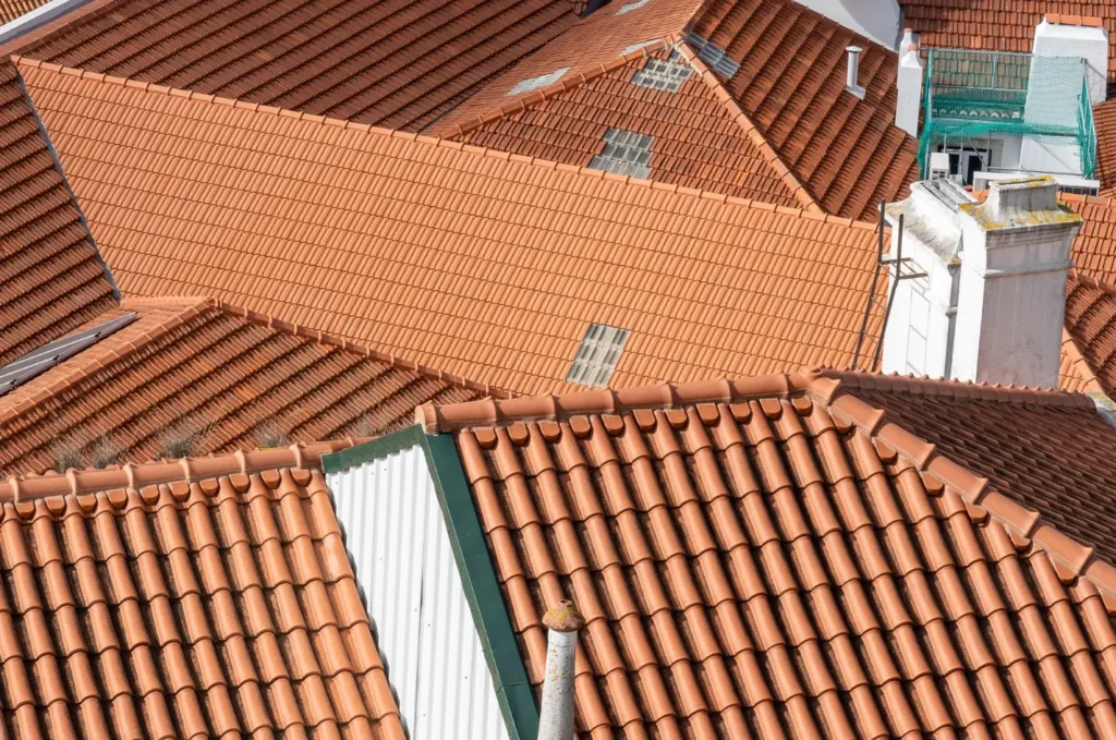 Slate tile roofing materials arranged across a pitched roof with a natural, textured finish