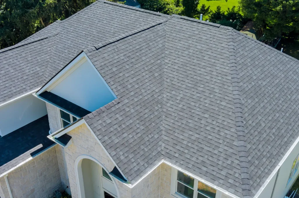 Finished roof replacement showing a clean new shingle roof on a residential property