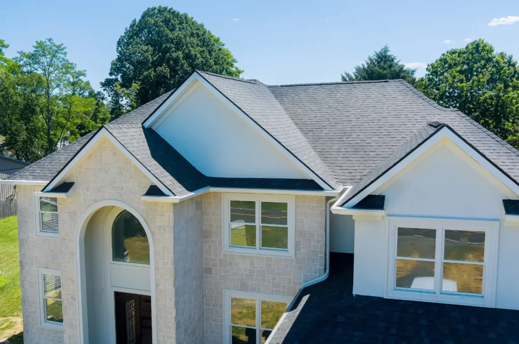Close-up of granule loss on asphalt shingles before roof rejuvenation restores the surface