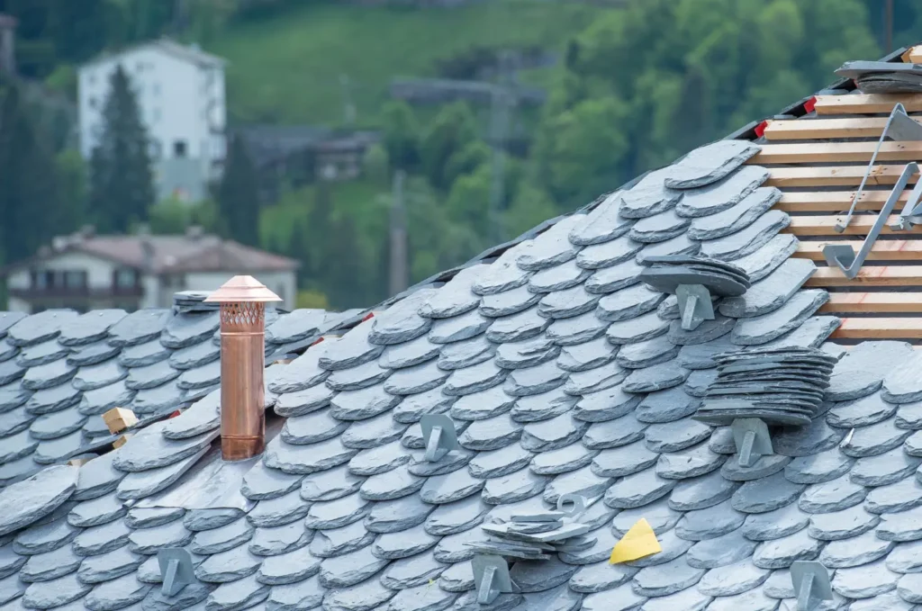 Slate roof tiles installed in even rows across a steep residential roof