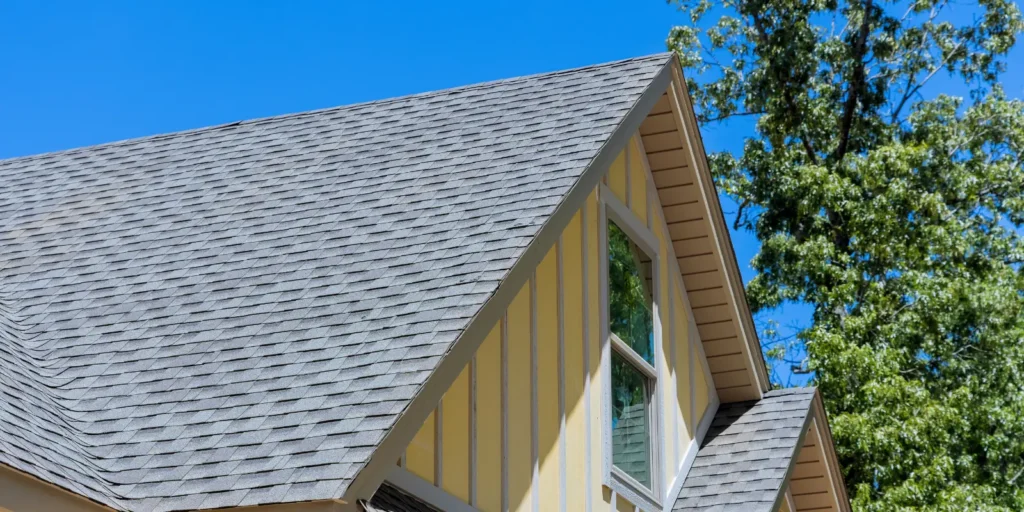 Roof rejuvenation treatment being applied to asphalt shingles on a residential roof